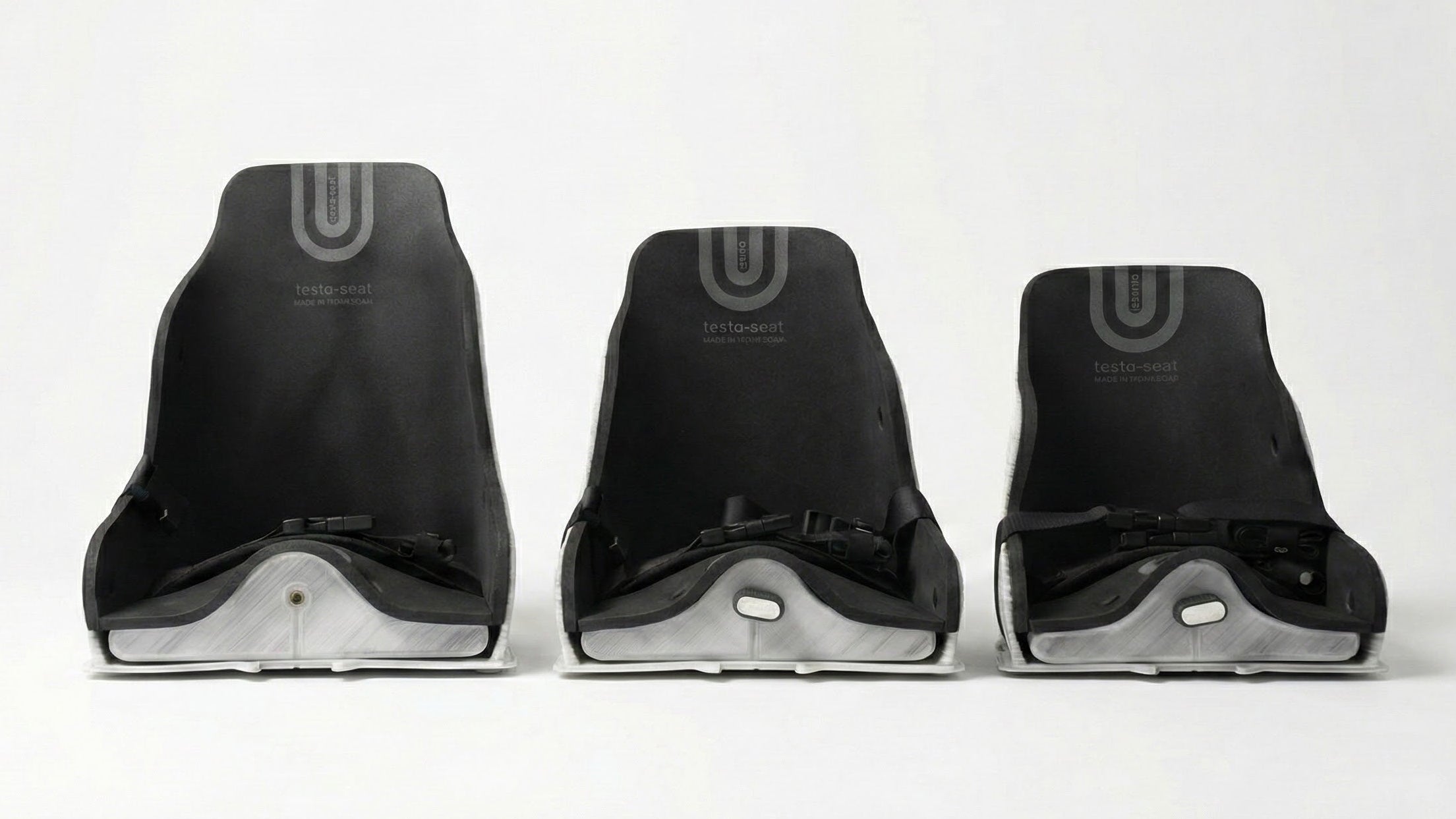 Three black standard testa-seats on a white background